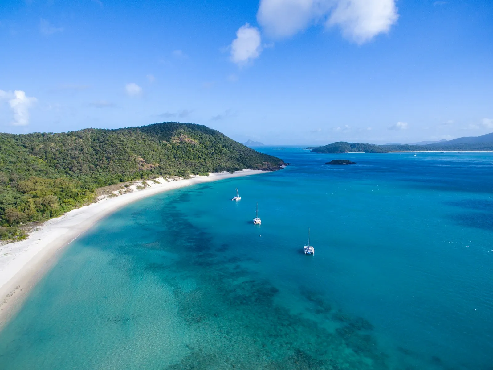 Boats on turquoise water in the Whitsundays